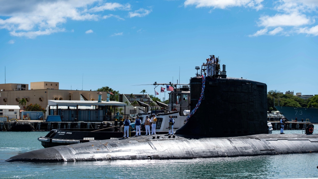 In this photo provided by U.S. Navy, the Virginia-class fast-attack submarine USS Illinois (SSN 786) returns home to Joint Base Pearl Harbor-Hickam from a deployment in the 7th Fleet area of responsibility on Sept. 13, 2021. (Michael B. Zingaro/U.S. Navy via AP) 