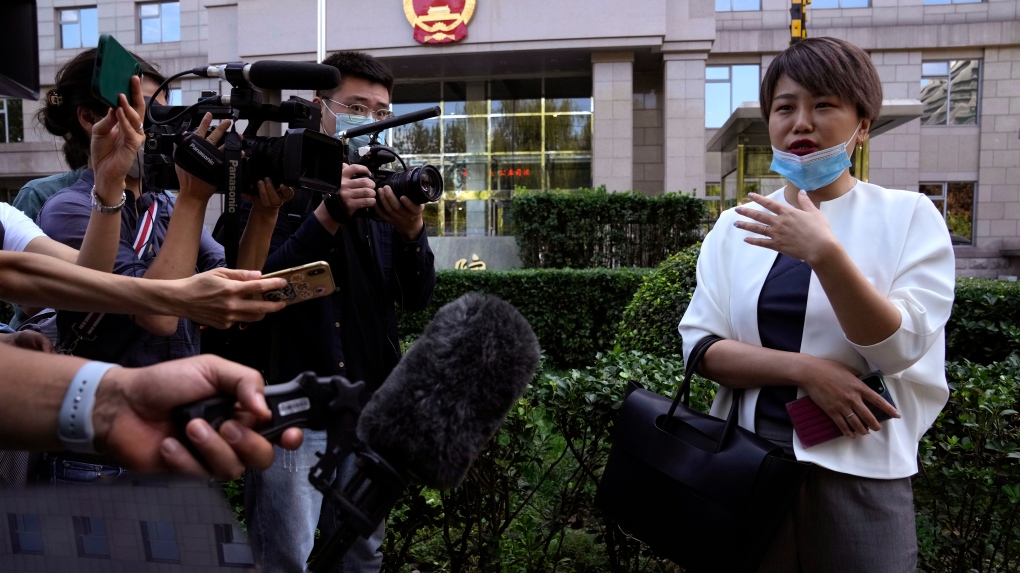 Teresa Xu speaks to journalists before a court session at the Chaoyang People's Court in Beijing, China, Friday, Sept. 17, 2021. (AP Photo/Ng Han Guan) 