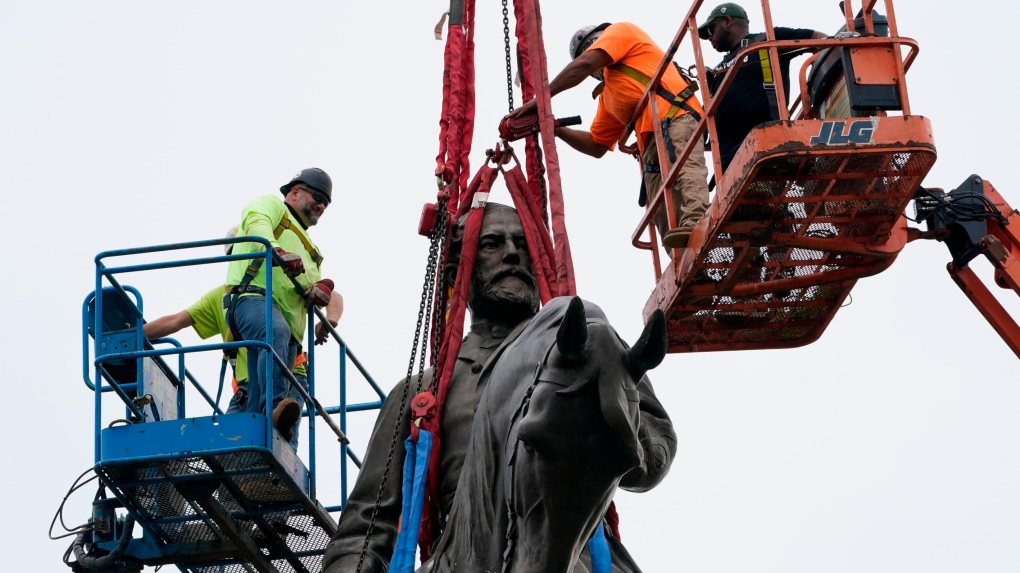 Crews work to remove the towering statue of Confederate General Robert E. Lee on Monument Avenue, on September 8, in Richmond, Va. (Steve Helber/Pool/AP/CNN)