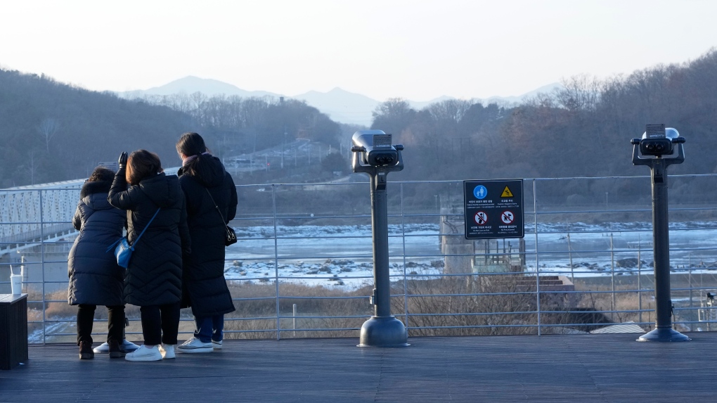 People watch the North Korean side at the Imjingak Pavilion in Paju, near the border with North Korea, South Korea, Friday, Jan. 14, 2022. (AP Photo/Ahn Young-joon) 