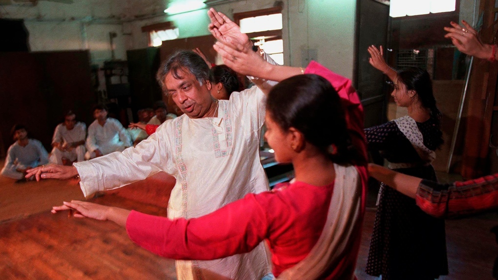 Indian classical Kathak dance guru Birju Maharaj teaches students at his studio in New Delhi on Sept. 26, 1997. (AP Photo/John Moore, File) 