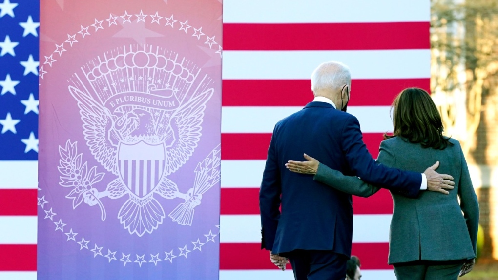 U.S. President Joe Biden and Vice President Kamala Harris walk off stage after speaking on the grounds of Morehouse College and Clark Atlanta University, on Jan. 11, 2022. (Patrick Semansky / AP) 