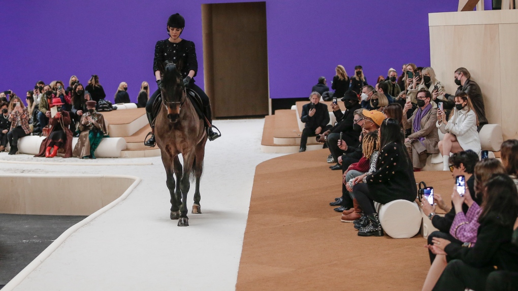 Charlotte Casiraghi rides a horse as she wears a creation for the Chanel Spring-Summer 2022 Haute Couture fashion collection collection, in Paris on Jan. 25, 2022. (AP Photo/Lewis Joly) 