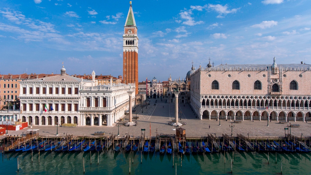 An aerial view taken on April 25, 2020 over Venice shows St. Mark's Square, the Bell Tower, the Doges Palace and gondolas moored at the Riva degli Schiavoni embankment during the country's lockdown aimed at curbing the spread of the COVID-19 infection. (MARCO SABADIN/AFP via Getty Images/CNN)