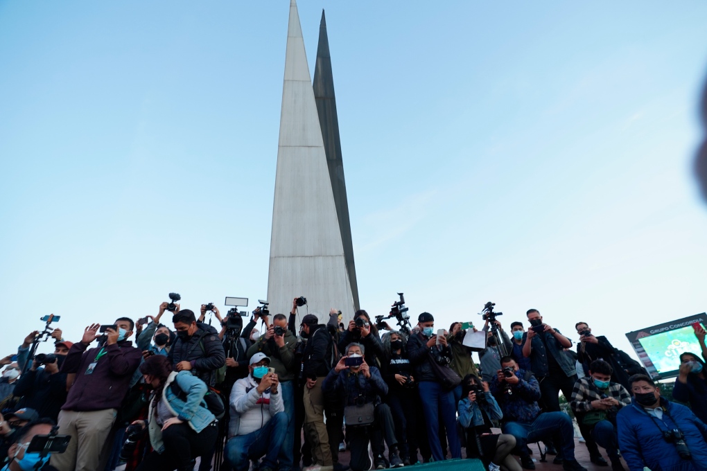 People and journalists join a national protest against the murder of journalist Lourdes Maldonado and freelance photojournalist Margarito Marti­nez at the Mexico monument in Tijuana, Mexico, Tuesday, Jan. 25, 2022. (AP Photo/Marco Ugarte) 
