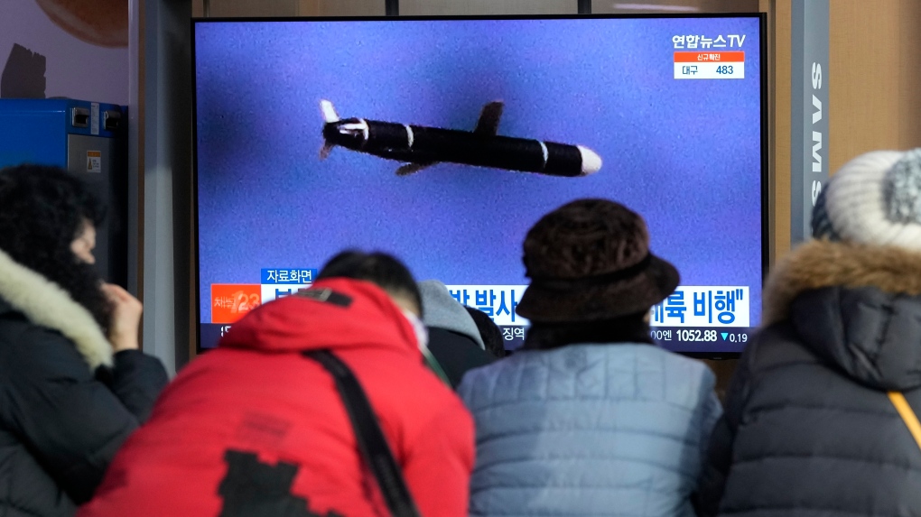People watch a TV showing a file image of North Korea's missile launch during a news program at the Seoul Railway Station in Seoul, South Korea, Tuesday, Jan. 25, 2022. \(AP Photo/Ahn Young-joon) 
