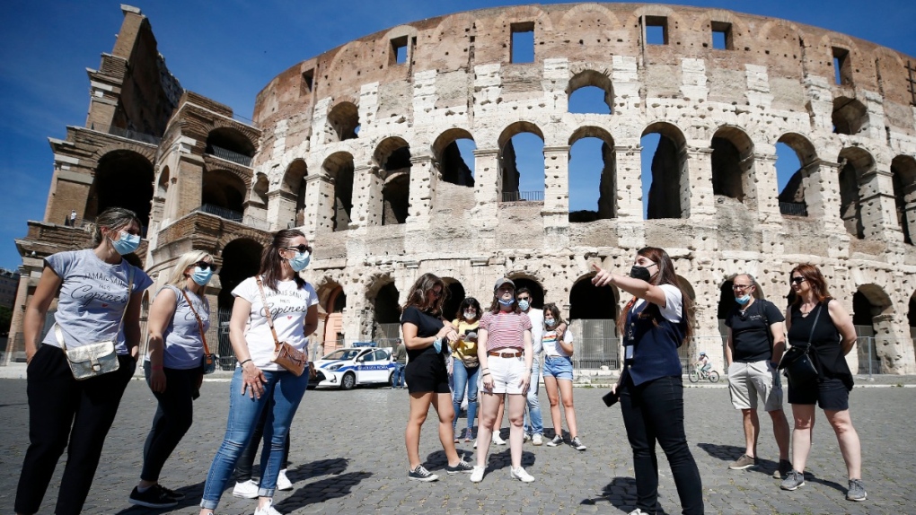 Tourists listen to a tour guide outside the ancient Colosseum in Rome, on May 21, 2021. (Cecilia Fabiano / LaPresse via AP) 