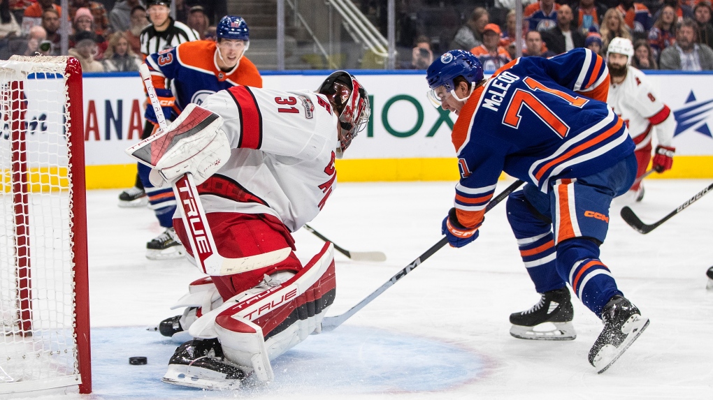 Edmonton Oilers' Ryan McLeod (71) moves the puck against the Carolina  Hurricanes during the first period of an NHL hockey game in Raleigh, N.C.,  Sunday, Feb. 27, 2022. (AP Photo/Karl B DeBlaker