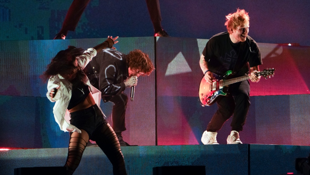 Oli Sykes, centre, of Bring Me The Horizon and Ed Sheeran perform at the Reading Music Festival, England, Friday, Aug. 27, 2022. (Photo by Scott Garfitt/Invision/AP)