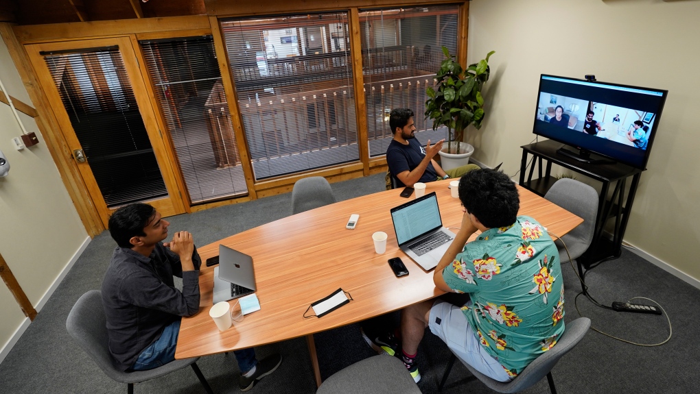 RunX CEO Ankur Dahiya, top center, takes part in a video meeting along with employees Nitin Aggarwal, left, and JD Palomino, lower right, at a rented office in San Francisco, Friday, Aug. 27, 2021. (AP Photo/Eric Risberg)
