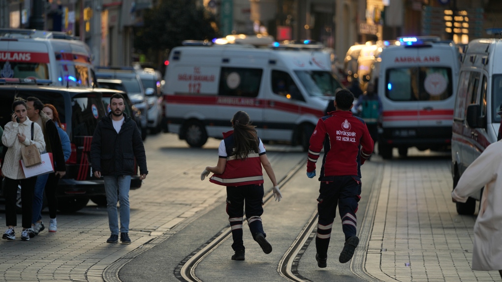 Security and ambulances at the scene after an explosion on Istanbul's popular pedestrian Istiklal Avenue on Nov. 13, 2022. Istanbul Gov. Ali Yerlikaya tweeted that the explosion occurred at about 4:20 p.m. (1320 GMT) and that there were deaths and injuries, but he did not say how many. The cause of the explosion was not clear. (AP Photo/Francisco Seco)