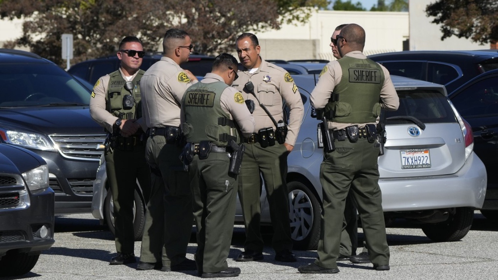 Los Angeles County sheriff's personnel gather in the parking lot of the department's training academy in Whittier, Calif., Wednesday, Nov. 16, 2022. A car struck 22 Los Angeles County sheriff's recruits on a training run around dawn Wednesday and five were critically injured, authorities said. (AP Photo/Jae C. Hong)