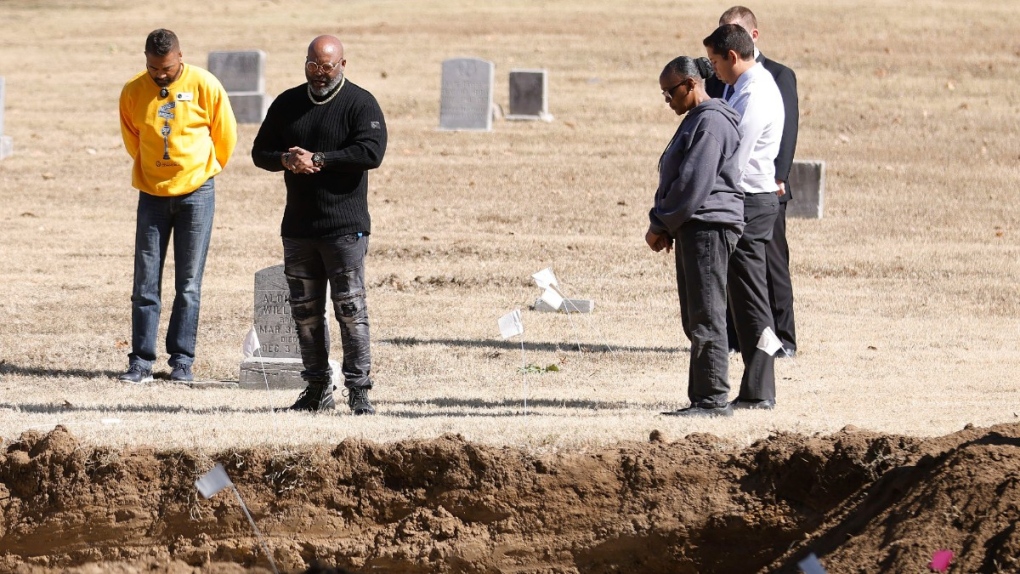 Pastor Rodney Goss with Morning Star Baptist Church leads a prayer during a reburial ceremony at Oaklawn Cemetery during an excavation while searching for bodies from the 1921 Tulsa Race Massacre, Oct. 27, 2022, in Tulsa, Okla. (Mike Simons/Tulsa World via AP)
