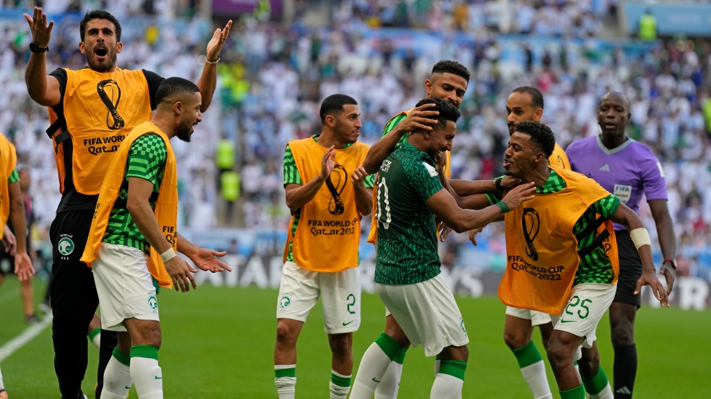 Saudi Arabia's Salem Al-Dawsari, centre, celebrates with teammates after scoring his side's second goal during the World Cup group C soccer match between Argentina and Saudi Arabia at the Lusail Stadium in Lusail, Qatar, Tuesday, Nov. 22, 2022. (AP Photo/Ricardo Mazalan)