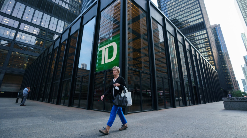 A person walks past a TD Bank sign in the financial district in Toronto on Tuesday, Sept. 20, 2022. THE CANADIAN PRESS/Alex Lupul 
