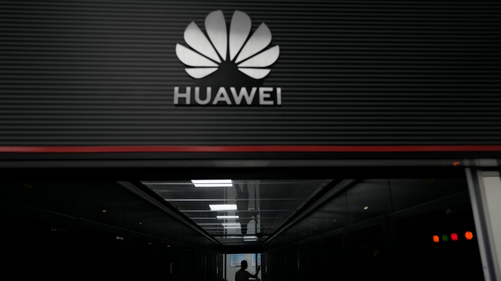 A technician stands at the entrance to a Huawei 5G data server centre at the Guangdong Second Provincial General Hospital in Guangzhou, in southern China's Guangdong province on Sept. 26, 2021. The U.S. is banning the sale of communications equipment made by Chinese companies Huawei and ZTE and restricting the use of some China-made video surveillance systems, citing an unacceptable risk to national security. (AP Photo/Ng Han Guan)