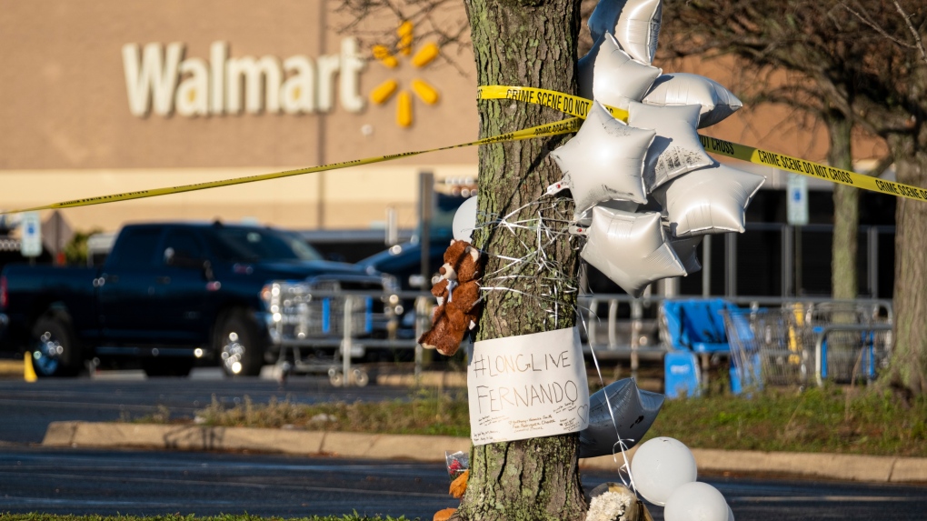 Balloon and a Teddy bear adorn a memorial for teenager Fernando Chavez-Barron, Friday, Nov. 25, 2022 , one of six killed in a Chesapeake, Va., Walmart mass shooting earlier in the week. (Billy Schuerman/The Virginian-Pilot via AP)