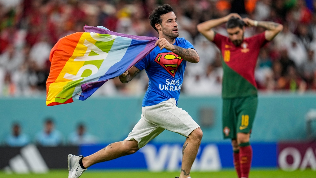Protester with rainbow flag runs onto field at World Cup