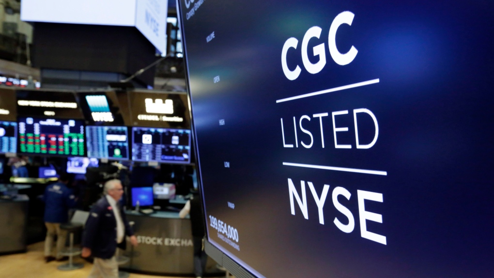 The logo for Canada's Canopy Growth Corp. appears on a screen above a trading post on the floor of the New York Stock Exchange on May 31, 2018. Canopy Growth Corp. says it is laying off 500 employees and closing its facilities in Aldergrove and Delta, B.C. THE CANADIAN PRESS/AP, Richard Drew