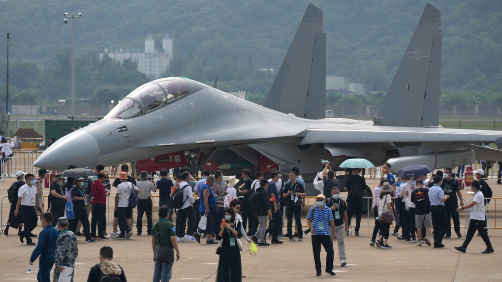Visitors look at the Chinese military's J-16D electronic warfare airplane during 13th China International Aviation and Aerospace Exhibition, also known as Airshow China 2021, on Wednesday, Sept. 29, 2021, in Zhuhai in southern China's Guangdong province. (AP Photo/Ng Han Guan) 
