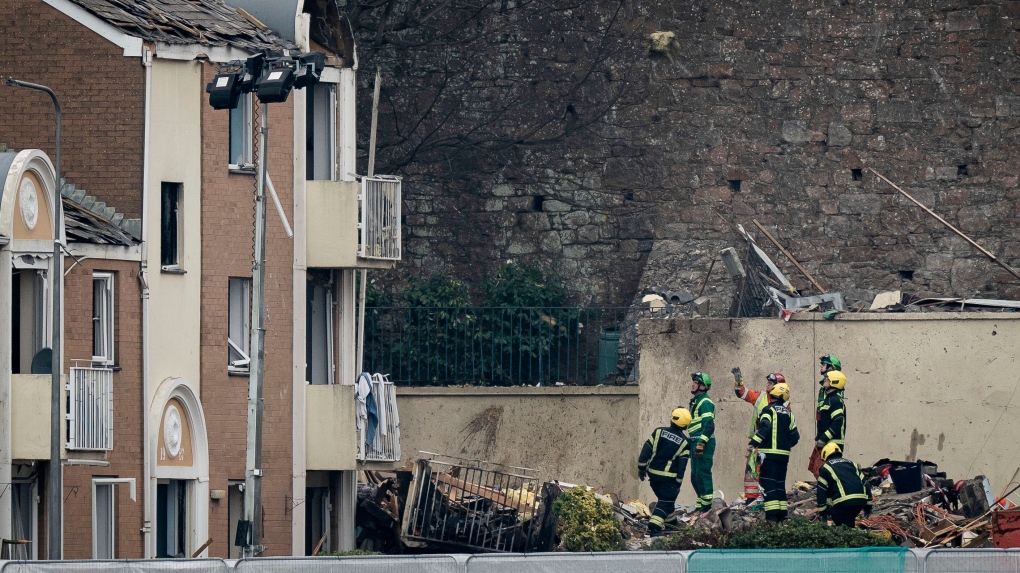 Specialist rescue teams at the scene of an explosion and fire at an apartment building in St Helier, Jersey, Channel Islands, on Dec. 11, 2022. An explosion and fire in an apartment building has killed at least three people and left several missing. The chief officer of the States of Jersey Police said “around a dozen” residents were missing on Saturday following the blast in the town of St Helier. (Aaron Chown/PA via AP)