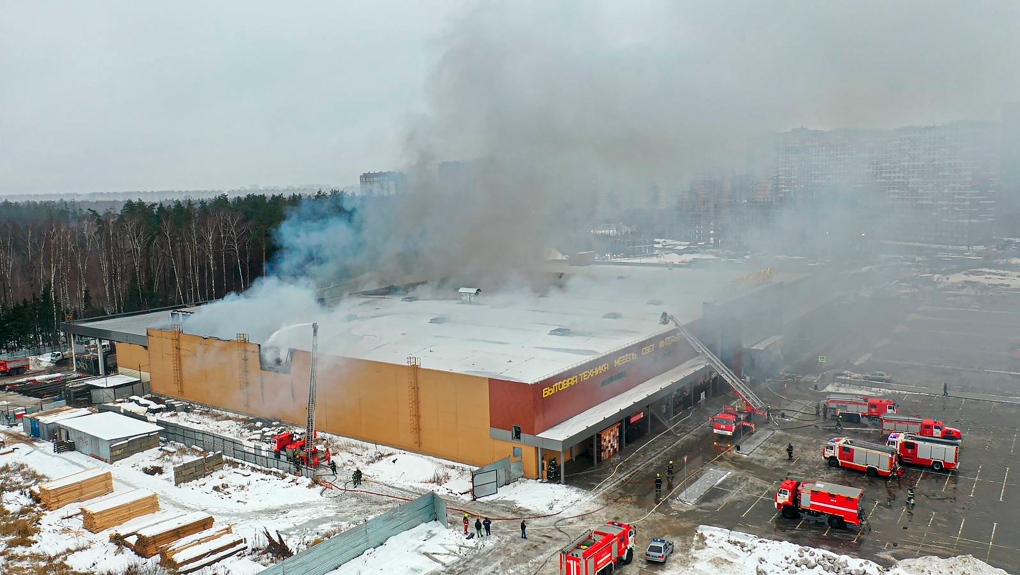 In this handout photo released by Russian Emergency Ministry Press Service, smoke rises from the mall in Balashikha, just outside Moscow, Russia, Monday, Dec. 12, 2022. (Russian Emergency Ministry Press Service via AP)