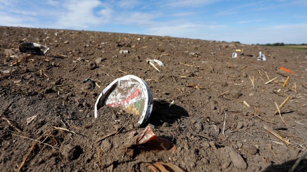 In this Sept. 9, 2018 photo plastic waste sits on a freshly cultivated field in Nauen, Germany. (AP Photo/Ferdinand Ostrop)