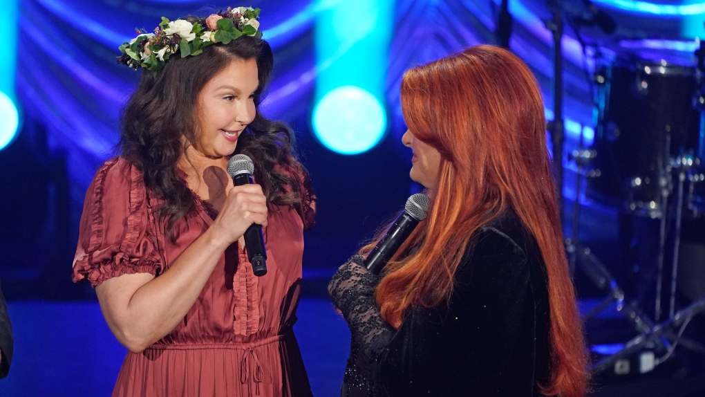 Ashley Judd, left, and Wynonna Judd speak during a tribute to their mother, country music star Naomi Judd, Sunday, May 15, 2022, in Nashville, Tenn. Naomi Judd died April 30. She was 76. (AP Photo/Mark Humphrey) 
