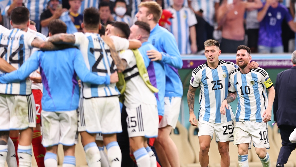 Lisandro Martinez and Lionel Messi, right, of Argentina celebrate winning the penalty shoot out during the FIFA World Cup Qatar 2022 quarter final match between Netherlands and Argentina at Lusail Stadium on Dec. 9, 2022 in Lusail City, Qatar. (Photo by Robbie Jay Barratt - AMA/Getty Images)