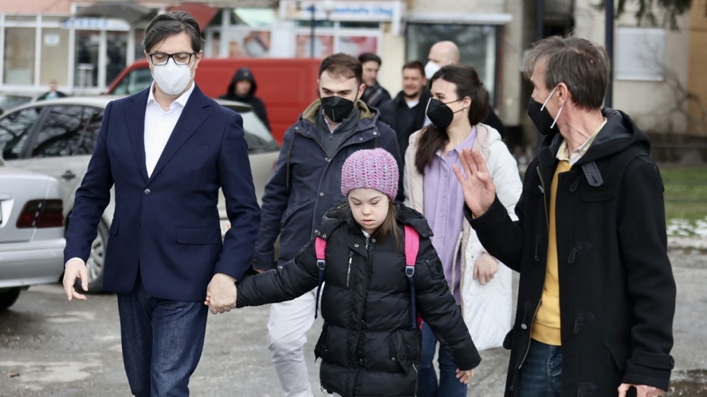 President Stevo Pendarovski held Embla Ademi's hand as he walked her to her school in the city of Gostivar on Monday. (via www.pretsedatel.mk)