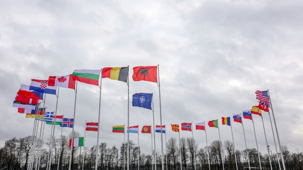 Flags of NATO member countries flap in the wind outside NATO headquarters in Brussels, Feb. 22, 2022. (AP Photo/Olivier Matthys)