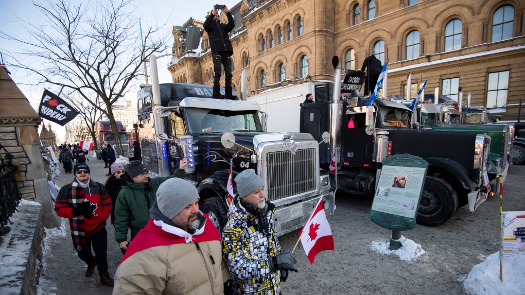 Trucks are parked along the sidewalk and on Wellington Street outside the Office of the Prime Minister and Privy Council during a rally against COVID-19 restrictions on Parliament Hill, which began as a cross-country convoy protesting a federal vaccine mandate for truckers, in Ottawa, on Sunday, Jan. 30, 2022. THE CANADIAN PRESS/Justin Tang