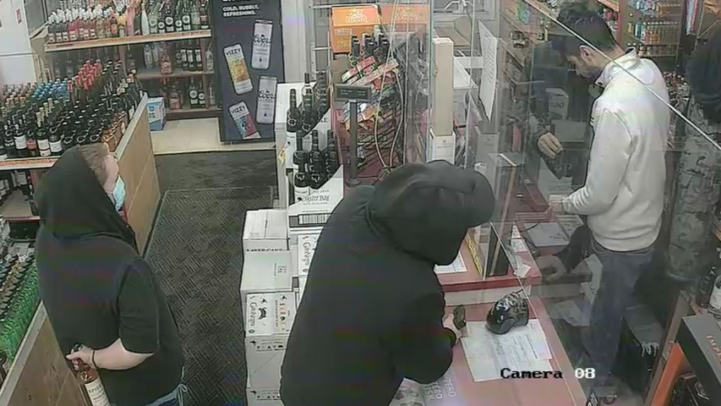 Caught on video: Suspect pulls handgun on clerks during Edmonton robbery
