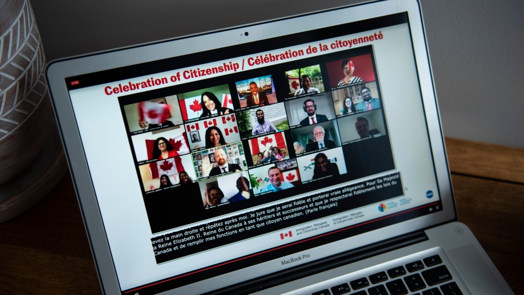 Participants celebrate becoming Canadian citizens after swearing the oath of citizenship during a virtual citizenship ceremony held over livestream due to the COVID-19 pandemic, on Canada Day, Wednesday, July 1, 2020, seen on a computer in Ottawa. (THE CANADIAN PRESS/Justin Tang)