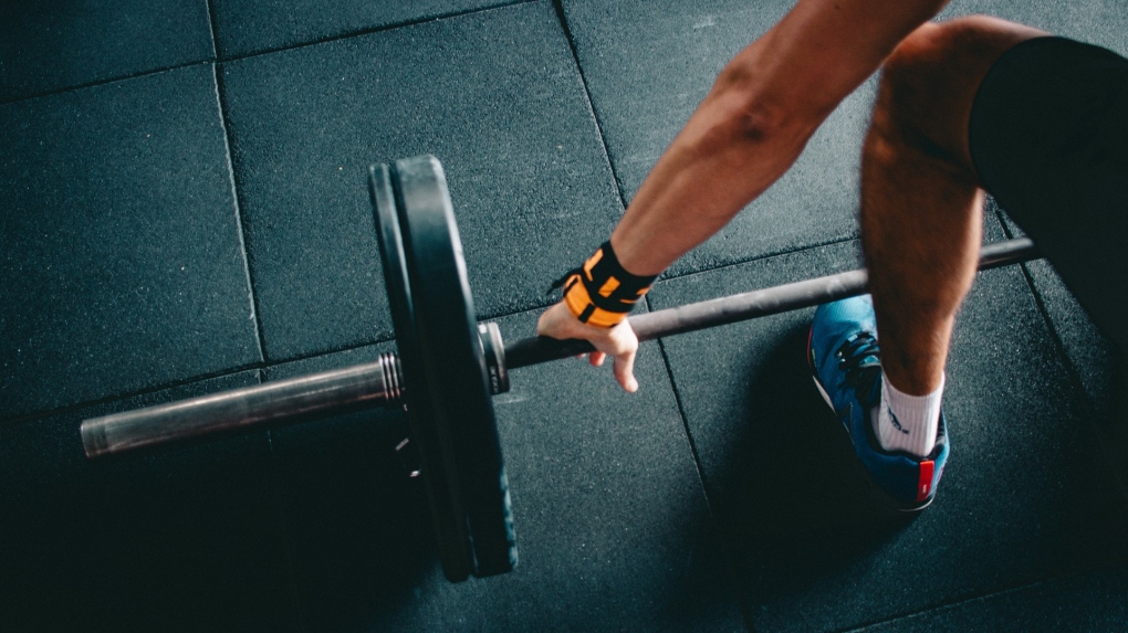 A person is seen lifting weights in this stock photo. (Victor Freitas/Pexels)