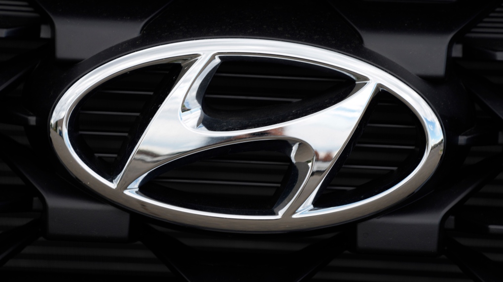 FILE - The Hyundai logo shines off the grille of an unsold vehicle at a Hyundai dealership Sunday, Sept. 12, 2021, in Littleton, Colo. (AP Photo/David Zalubowski, File)