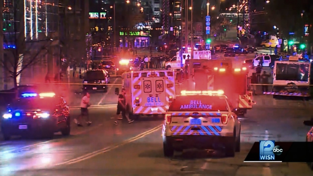 This photo taken from video provided by WISN 12 News shows police responding to the scene of a shooting at Water Street and Juneau Avenue in Milwaukee, Friday, May 13, 2022. (WISN 12 News via AP)