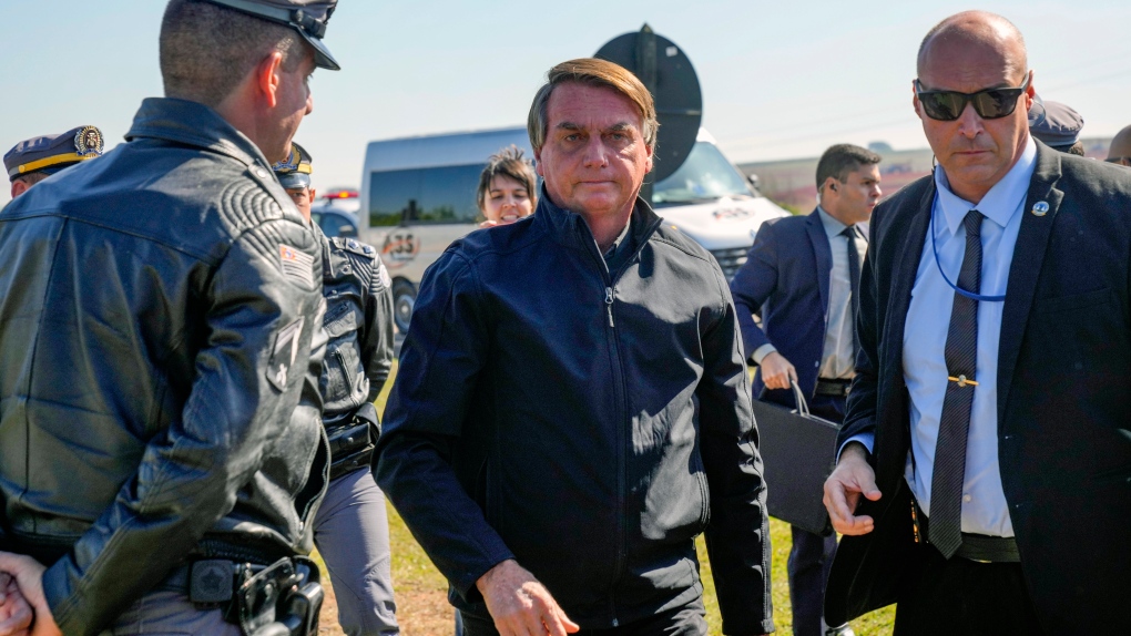 Brazilian President Jair Bolsonaro arrives to a resort hotel where he is expected to meet with Elon Musk in Porto Feliz, Brazil, Friday, May 20, 2022. (AP Photo/Andre Penner)
