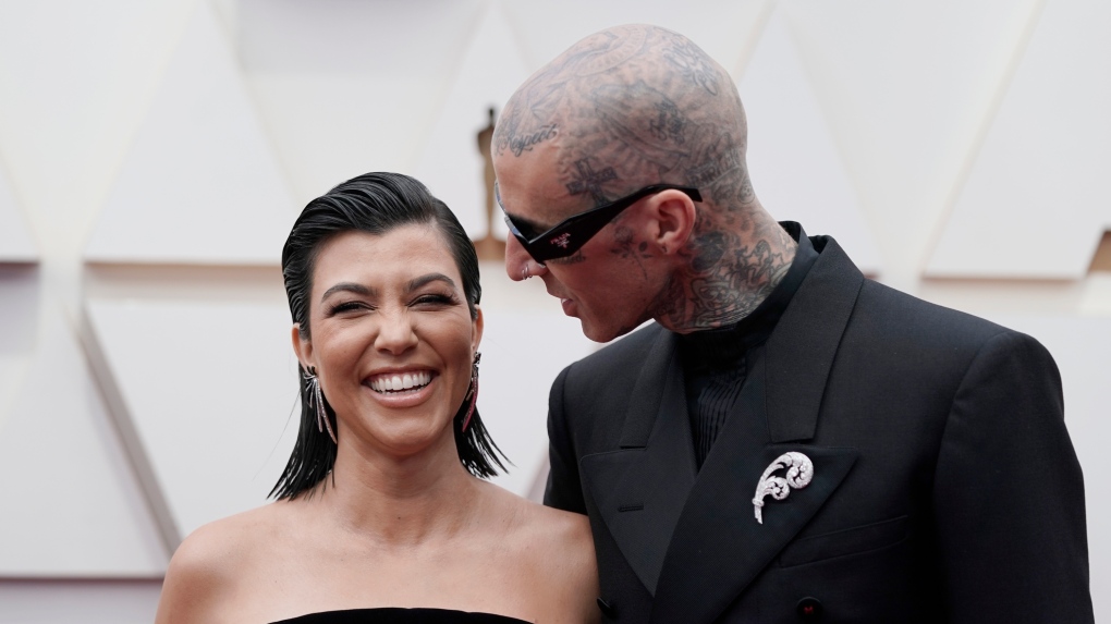 Kourtney Kardashian, left, and Travis Barker arrives at the Oscars on Sunday, March 27, 2022, at the Dolby Theatre in Los Angeles. (AP Photo/Jae C. Hong)