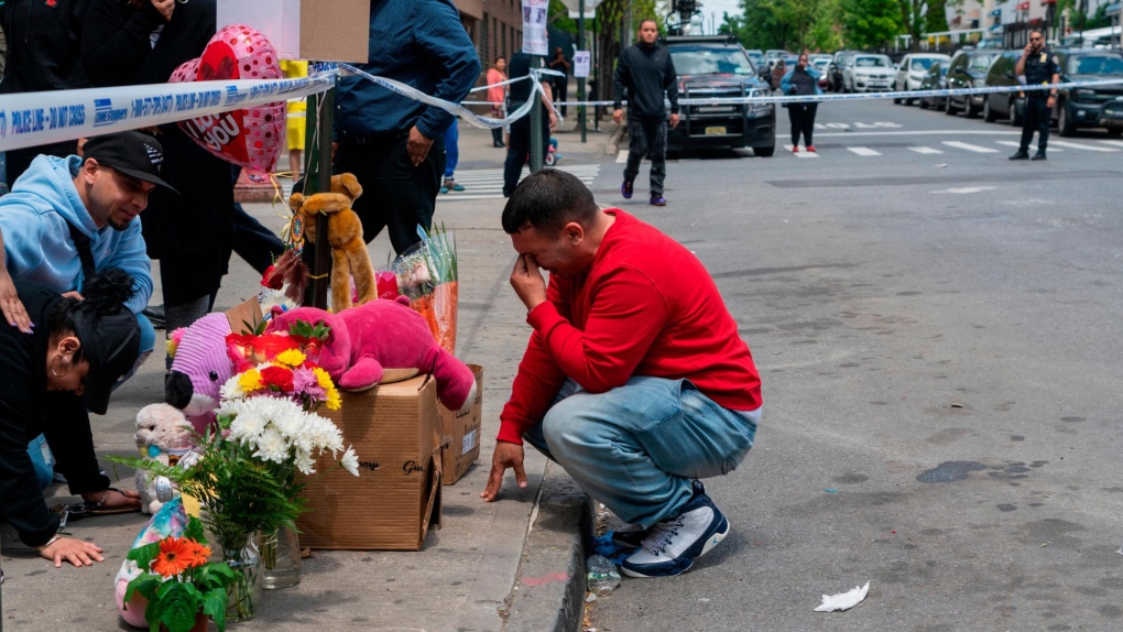 Family, friends and neighbours pay their respects at a makeshift memorial in the Bronx on May 17 for 11-year old Kyhara Tay, who was killed after being shot with a stray bullet. (Steve Sanchez/Sipa USA/AP/CNN)
