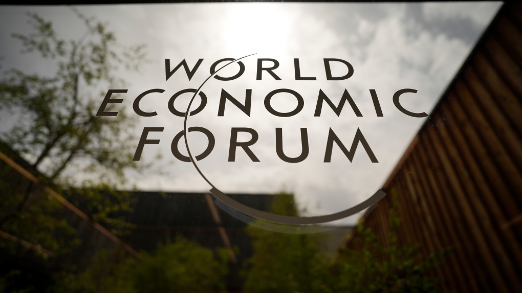 The logo of the World Economic Forum is displayed at a window of the venue prior to the opening of the event in Davos, Switzerland, Sunday, May 22, 2022.  (AP Photo/Markus Schreiber)