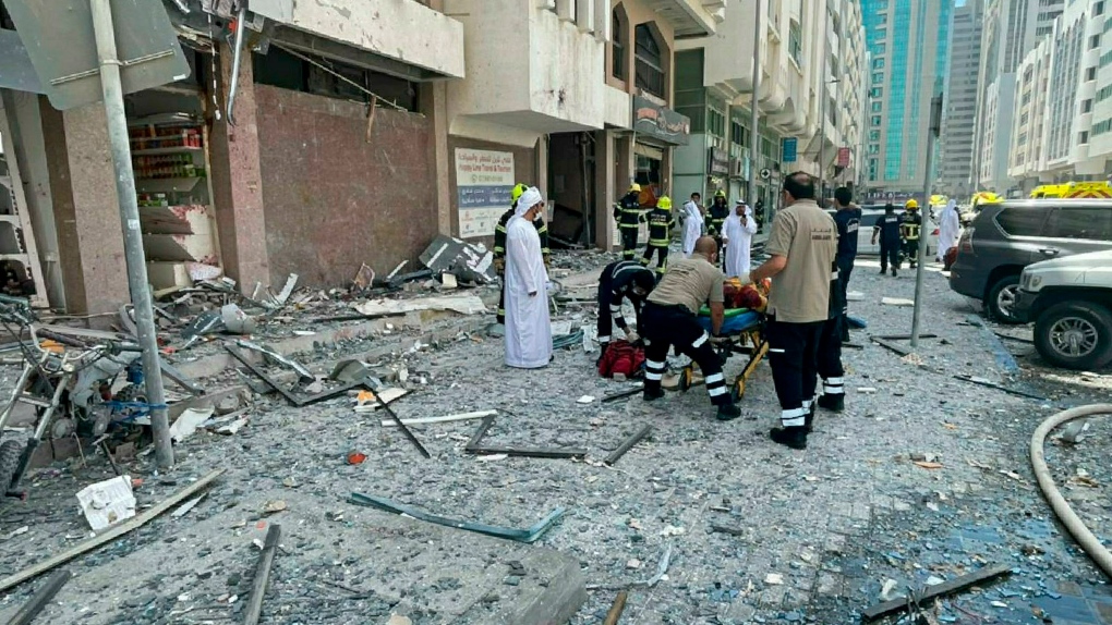 In this photo released by the Abu Dhabi Police, debris covers the street after an explosion in the Khalidiya district of Abu Dhabi, United Arab Emirates, Monday, May 23, 2022. (Abu Dhabi Police via AP)