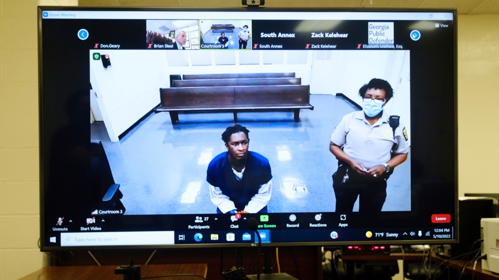 Atlanta rapper Young Thug, whose real name is Jeffery Lamar Williams, is displayed on a monitor as he waits during a virtual appearance before a Fulton County Magistrate judge on Tuesday, May 10, 2022, in Atlanta.  (Arvin Temkar/Atlanta Journal-Constitution via AP)