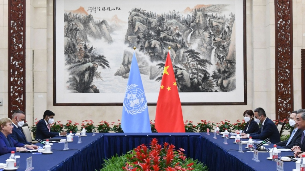 Chinese Foreign Minister Wang Yi, second right, meets with the United Nations High Commissioner for Human Rights Michelle Bachelet, left, in Guangzhou, China, on May 23, 2022. (Deng Hua / Xinhua via AP) 