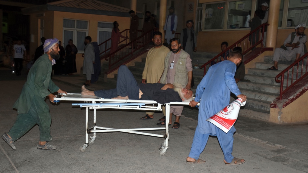 An injured man is transported to a hospital after a bombing in Mazar-e-Sharif, northern Afghanistan, Wednesday, May 25, 2022. (AP Photo/Masih Paeiz)