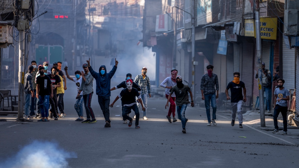 Protesters clash with security forces during a protest against sentencing of Kashmiri separatist leader Yasin Malik, in Srinagar, Indian controlled Kashmir, Wednesday, May 25, 2022.