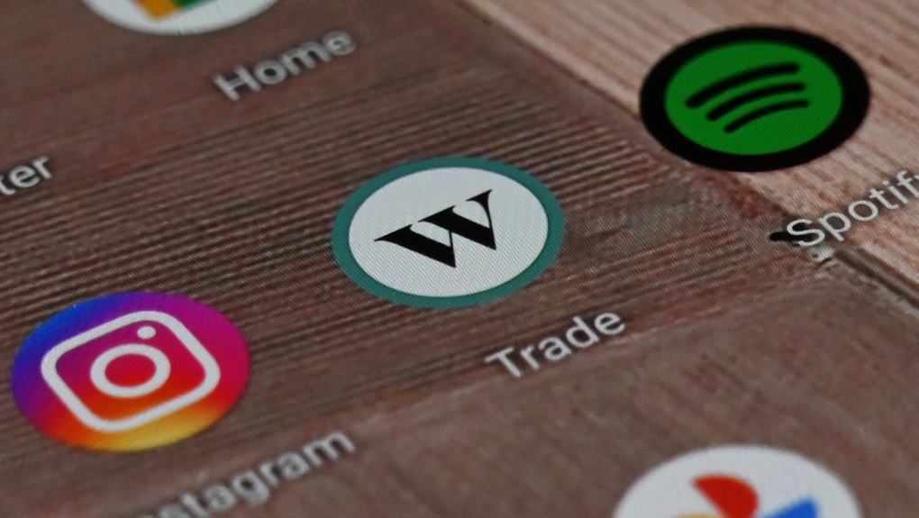 A Wealthsimple Trade app icon is shown on a smartphone on Tuesday, Dec. 15, 2020. (THE CANADIAN PRESS/Jesse Johnston)