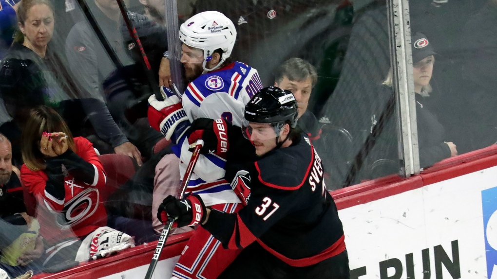 Carolina Hurricanes right wing Andrei Svechnikov checks New York Rangers defenceman Jacob Trouba into the boards during Game 5 of their second-round NHL playoff series, May 26, 2022, in Raleigh, N.C. (AP Photo/Chris Seward)