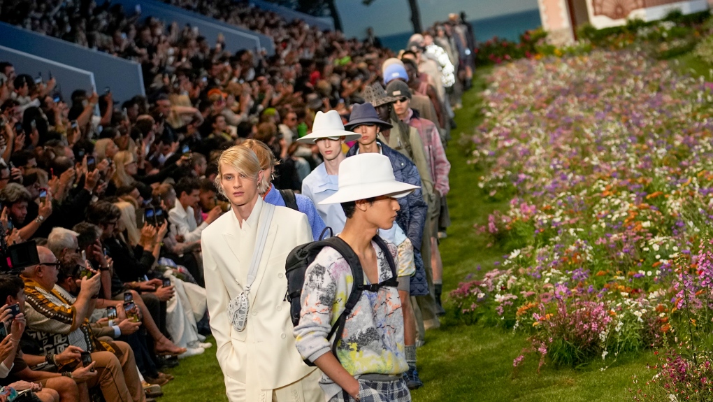 Models wear creations as part of the Dior men's Spring Summer 2023 collection presented in Paris, France, Friday, June 24, 2022. (AP Photo/Michel Euler)