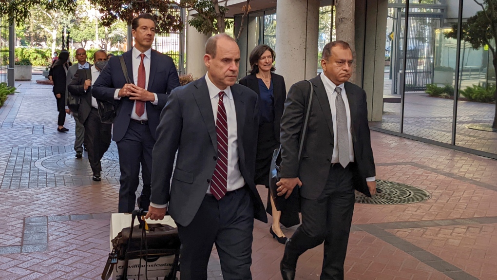Ramesh "Sunny" Balwani, right, the former lover and business partner of Theranos CEO Elizabeth Holmes, walks into federal court in San Jose, Calif., Friday, June 24, 2022, with his lawyers and family as his criminal trial moves toward its final phase. (AP Photo/Michael Liedtke)
